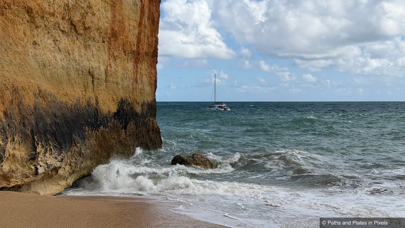 Praia de Benagil beach with waves crashing against the cliffs